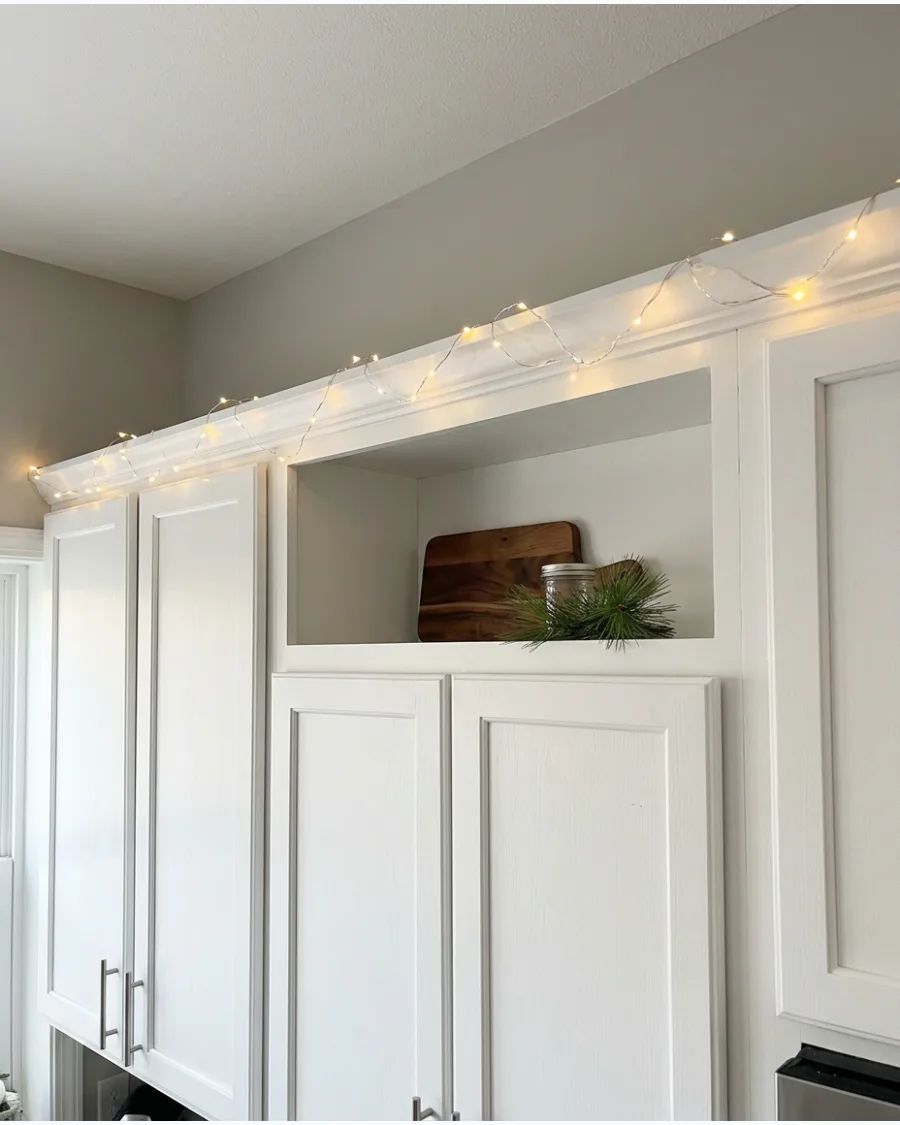 25. Warm Fairy Lights Above the Cabinets