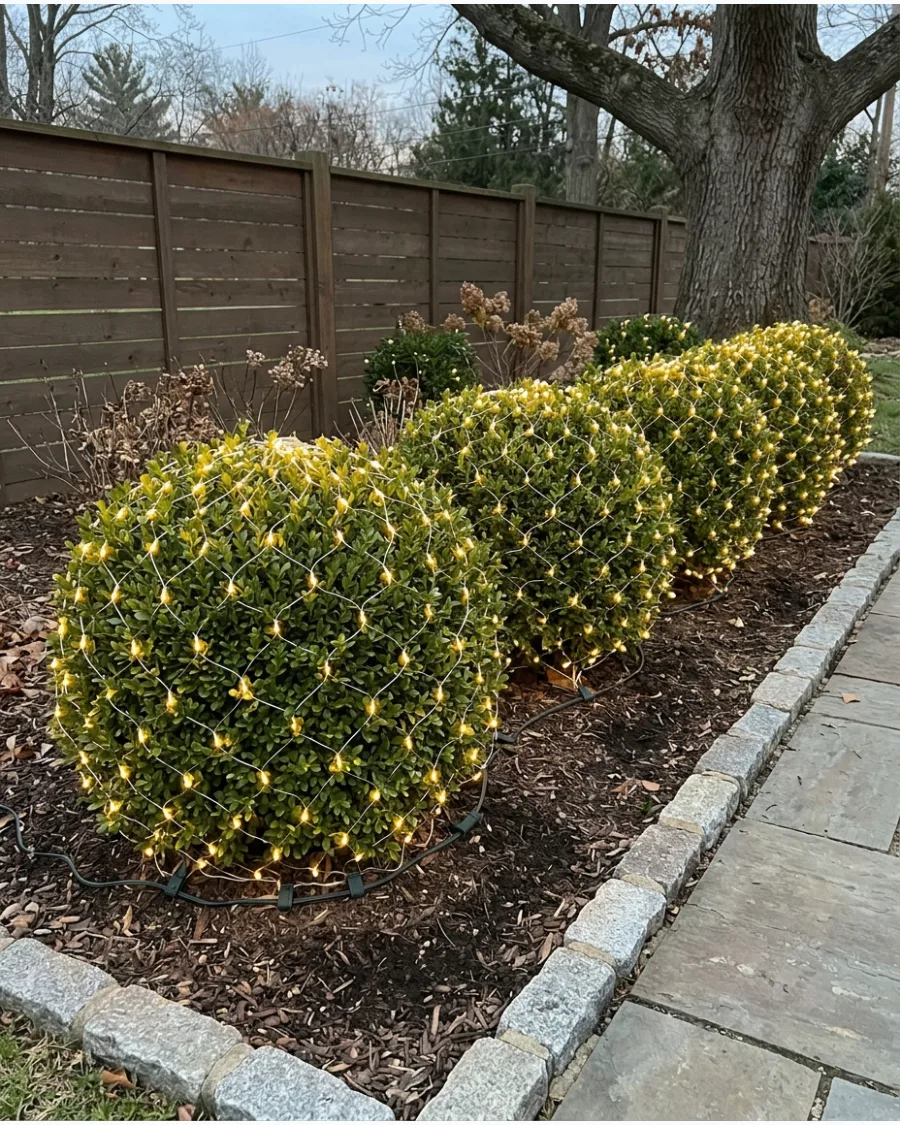 21. Warm Net Lights Over Garden Shrubs