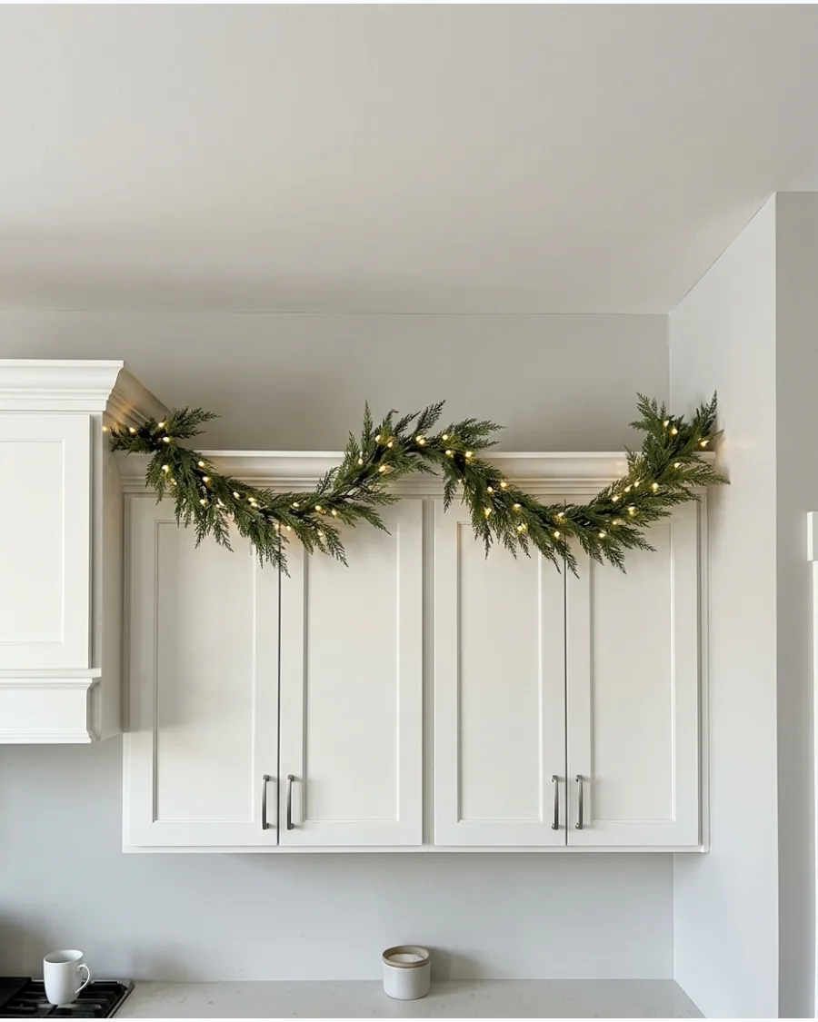 10. Pre-Lit Garland Above Kitchen Cabinets