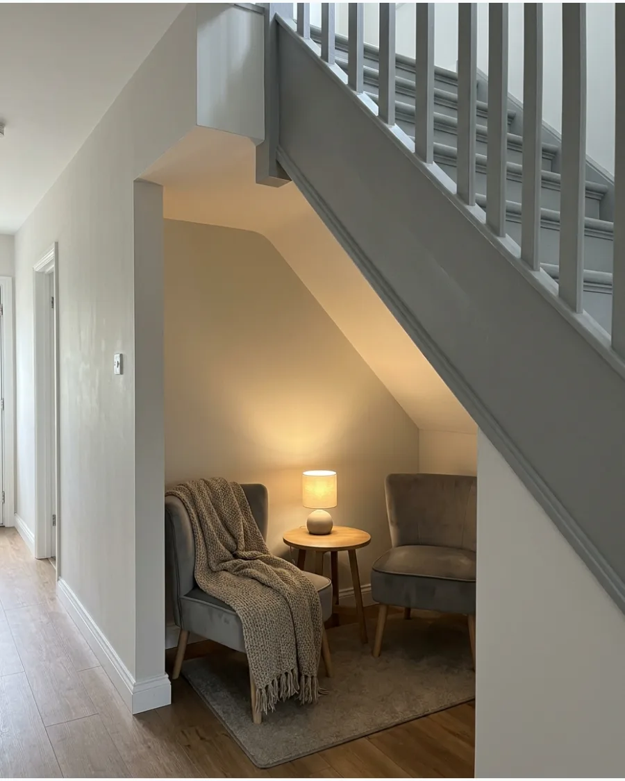 50. Cozy Conversation Nook Under Stairs