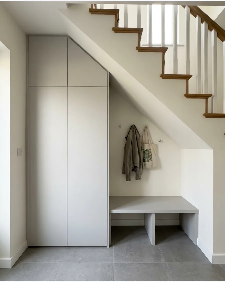 27. Minimalist Under-Stairs Mudroom