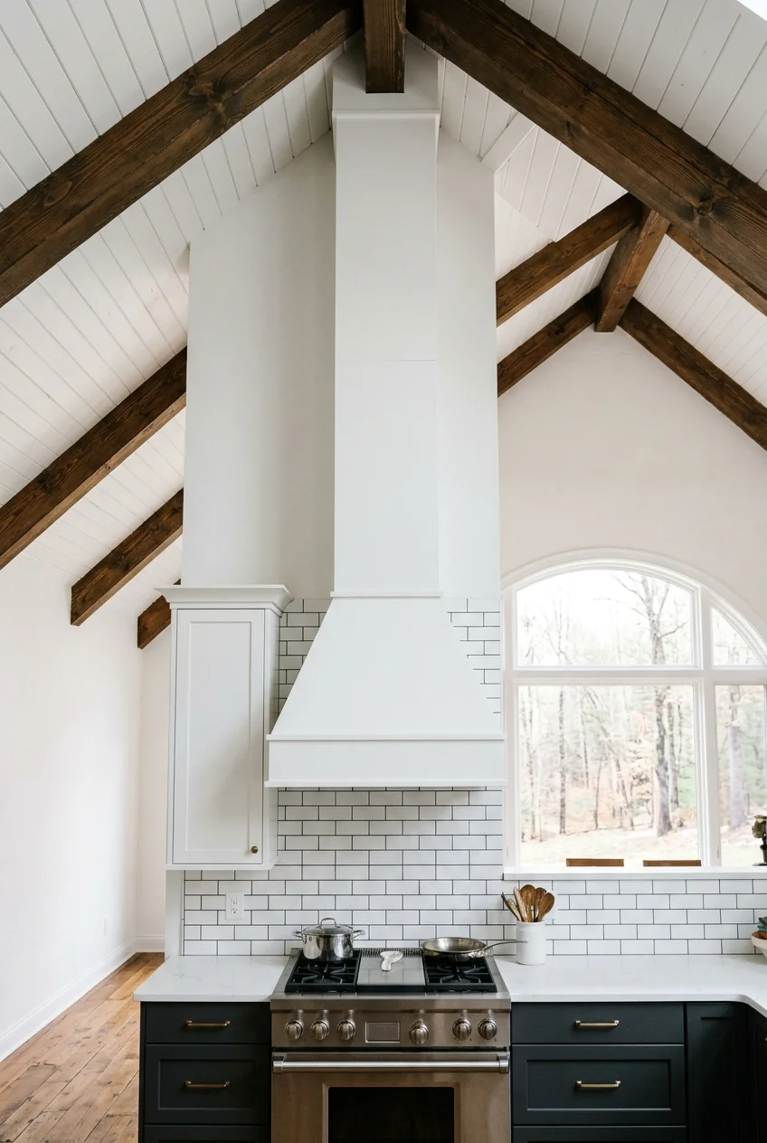 Tall range hood balanced beneath a vaulted ceiling.
