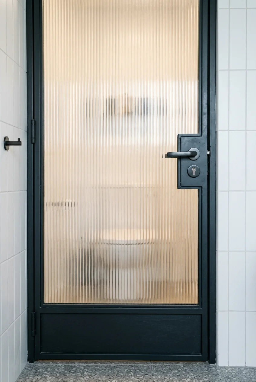 Reeded glass door providing light and privacy