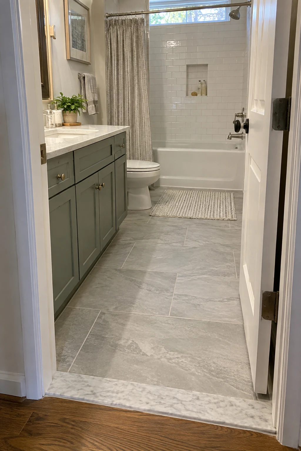 Bathroom doorway with a low neat transition between hall and bathroom floors